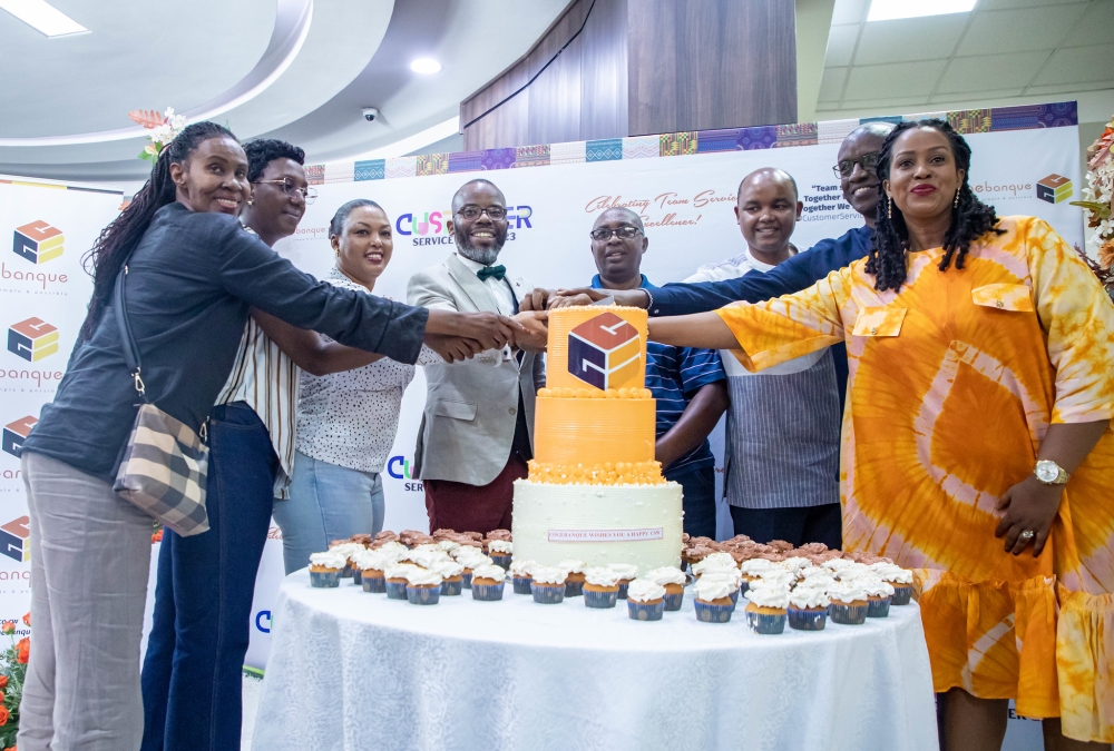 Cogebanque officials and clients cut a cake as  bank celebrates the annual Customer Service Week with a closing event on Friday, October 6. All photos by Dan Gatsinzi