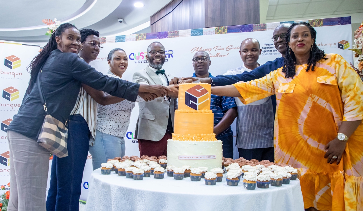 Cogebanque officials and clients cut a cake as  bank celebrates the annual Customer Service Week with a closing event on Friday, October 6. All photos by Dan Gatsinzi