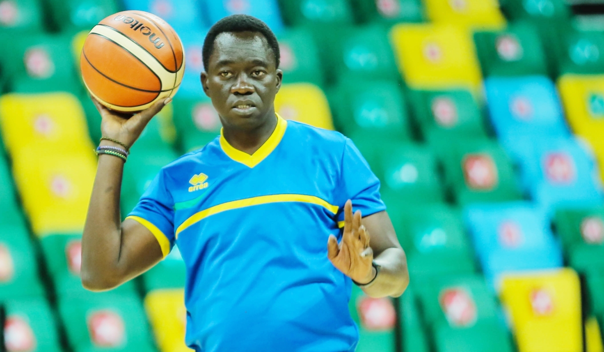 National Basketball team head coach, Cheikh Sarr gives instructions to players during a training session at Kigali Arena .File