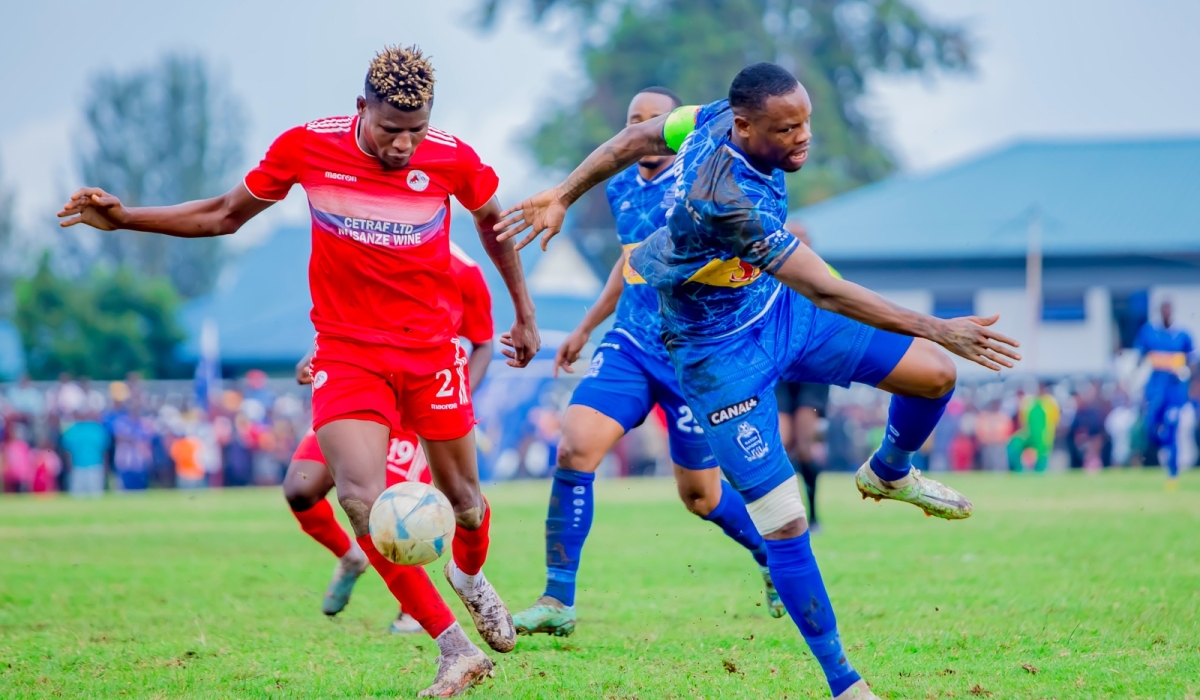 Musanze FC striker Peter Agblevor wins the ball against Rayon Sports skipper Abdoul Rwatubyaye before scoring the goal during a 1-0 league match at Ubworoherane stadium. Photo Christophe Renzaho.
