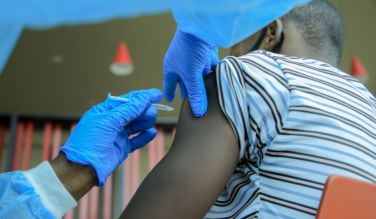 A health worker administers a Covid-19 vaccine in Kigali on August 23, 2021. CRAISH BAHIZI