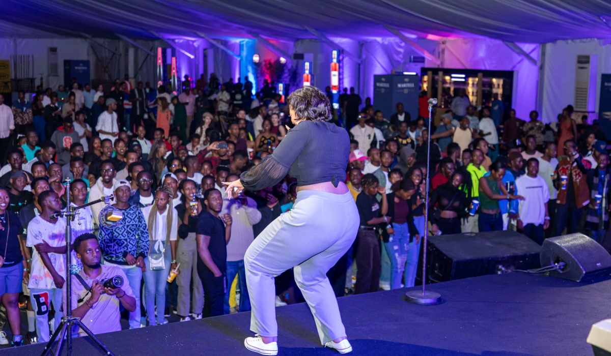 Revelers dance with an artiste during a pre-party event. Photos by Dan Gatsinzi