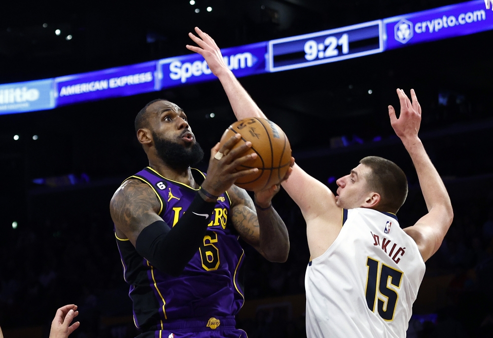 LeBron James #6 of the Los Angeles Lakers takes a shot against Nikola Jokic #15 of the Denver Nuggets in the second half at Crypto.com Arena on December 16, 2022 in Los Angeles, California. (Photo by Ronald Martinez/Getty Images)