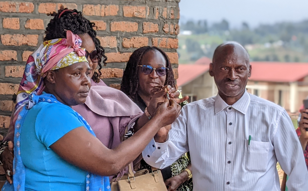 Theodomile Bagirubwiko, one of the ex-combatants receives his house. PHOTOS BY GERMAIN NSANZIMANA