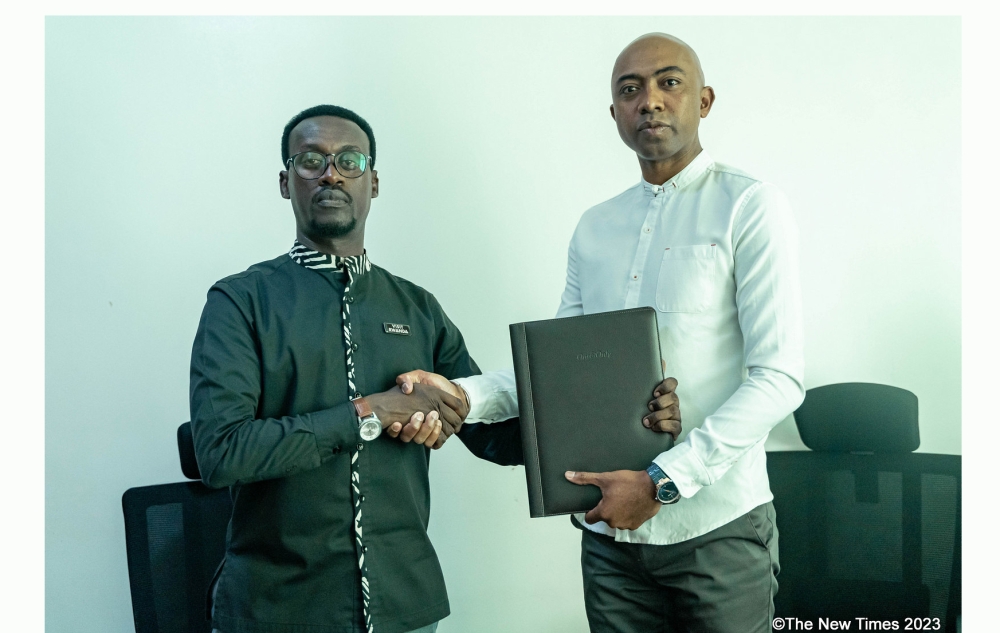 Frank Gisha Mugisha, Rwanda Chamber of Tourism Managing Director and Tojosoa Razafimahalefa, CTM’s Vice Chairman after signing the agreement in Kigali on October 31. PHOTOS. DAN GATSINZI