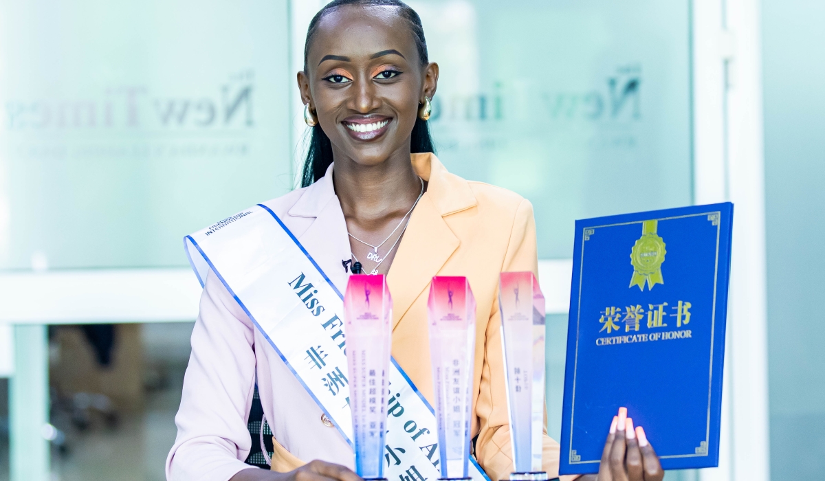 Sylvie Isimbi posing with her awards that she won in the Miss Friendship International pageant. PHOTO BY DAN GATSINZI