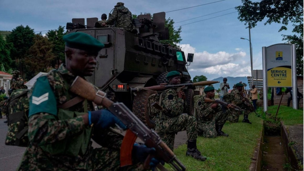 Members of Uganda Peoples&#039; Defence Forces position themselves on the Ugandan side of the border town in Bunagana, Democratic Republic of Congo on March 30, 2023. PHOTO: AFP