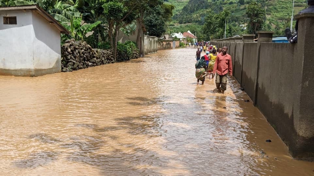 Rubavu residents wade through a flooded residential area in Nyundo sector on May 3. Rwanda is planning to roll out flood monitors in other parts of the country that are prone to flooding.