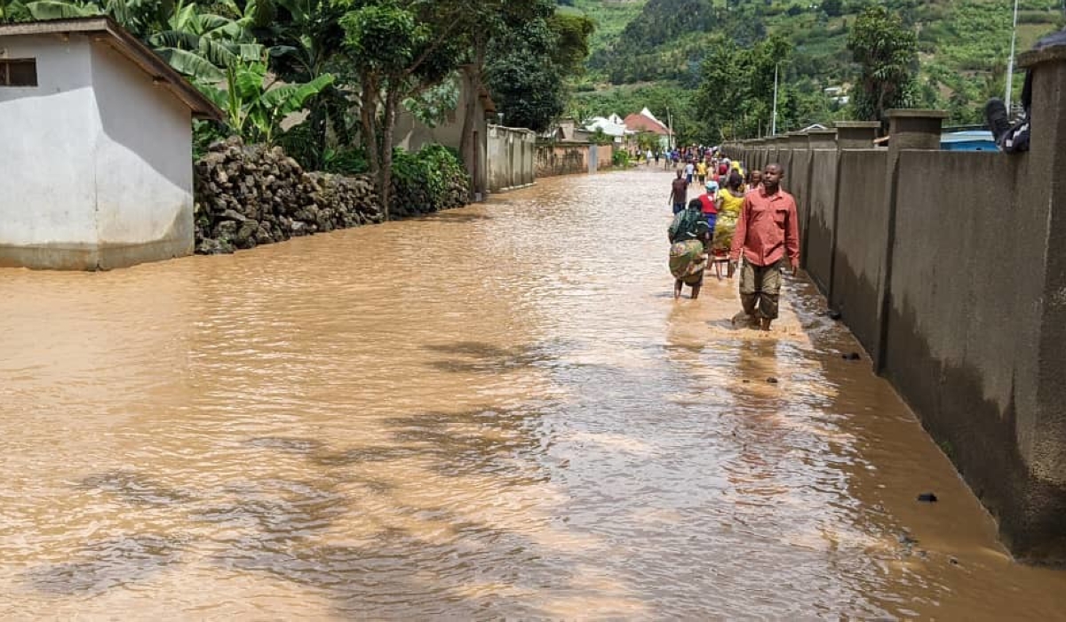 Rubavu residents wade through a flooded residential area in Nyundo sector on May 3. Rwanda is planning to roll out flood monitors in other parts of the country that are prone to flooding.