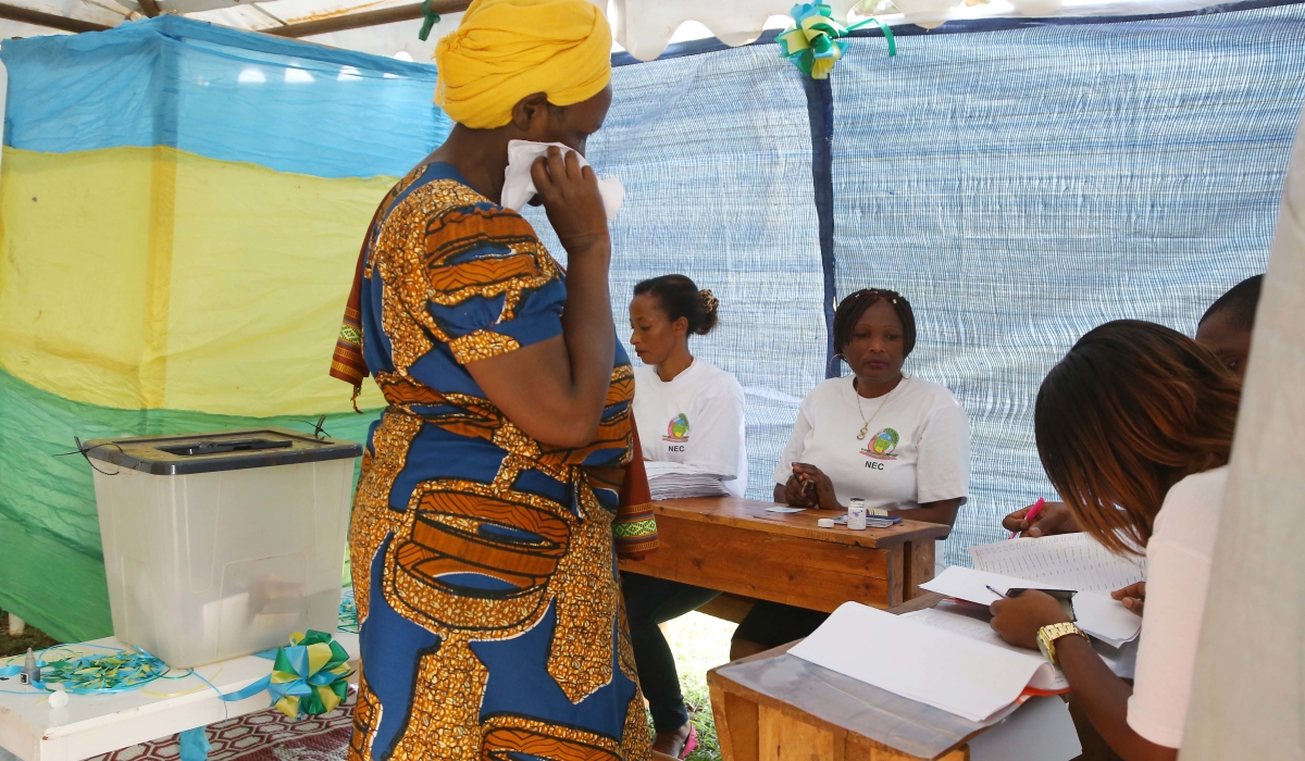 A voter talks to the electoral commission&#039;s volunteers before casting her vote during parliamentary elections in 2018. SAM NGENDAHIMANA