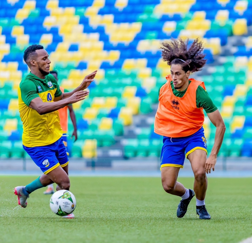 Amavubi&#039;s new player Hendrick Yves Mutamuliza who plays for Racing White Daring Molenbeek in Belgium tries to go past Patrick Sibomana during a training session.Courtesy