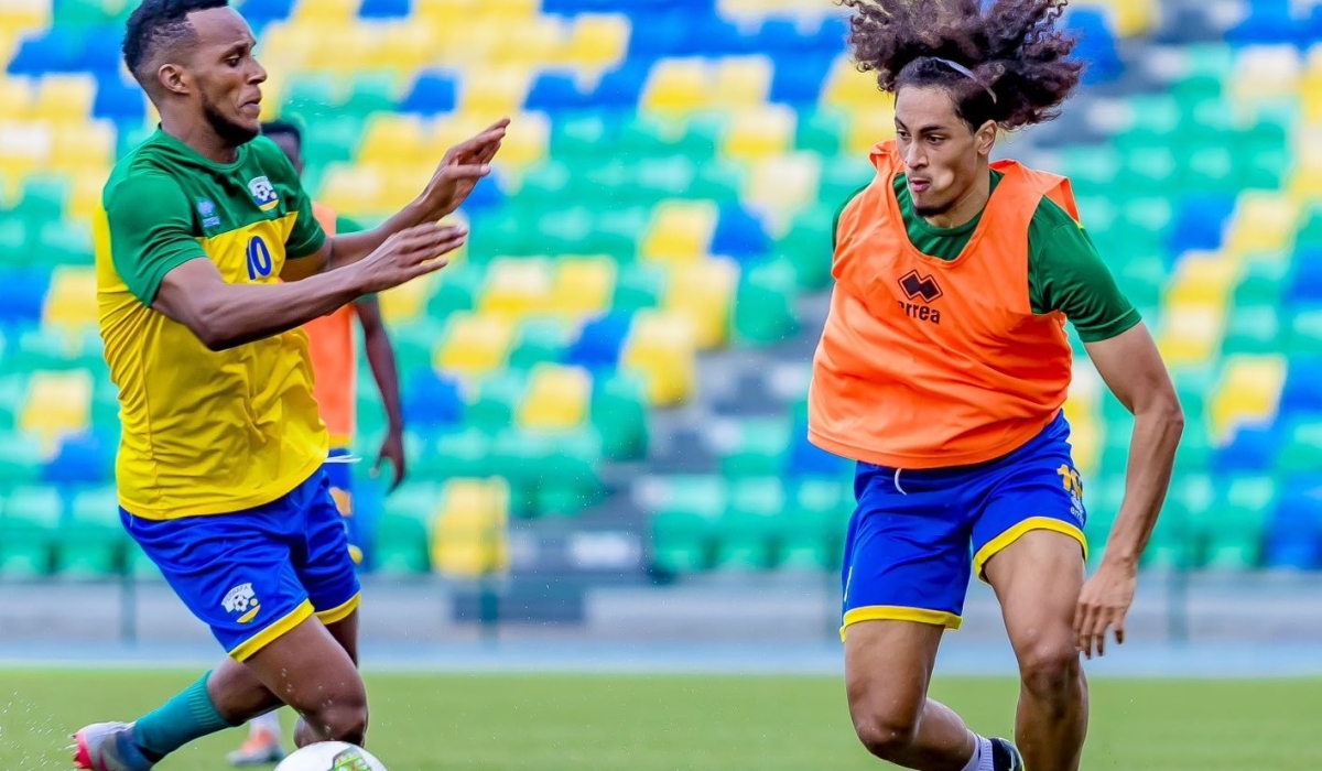Amavubi&#039;s new player Hendrick Yves Mutamuliza who plays for Racing White Daring Molenbeek in Belgium tries to go past Patrick Sibomana during a training session.Courtesy