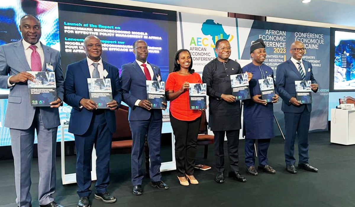 Officials hold a report document of the Benchmark Macroeconomic Models for Effective Policy Management in Africa during meeting. Courtesy 