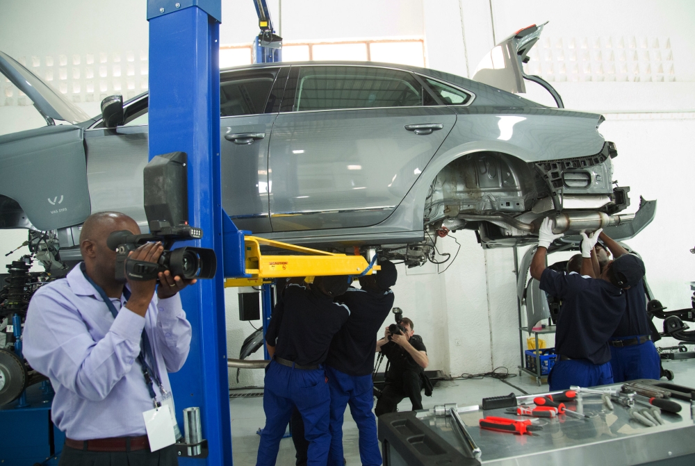 Mechanicians re-assemble a Volkswagen car at the firm at Kigali Special Economic Zone. SAM NGENDAHIMANA