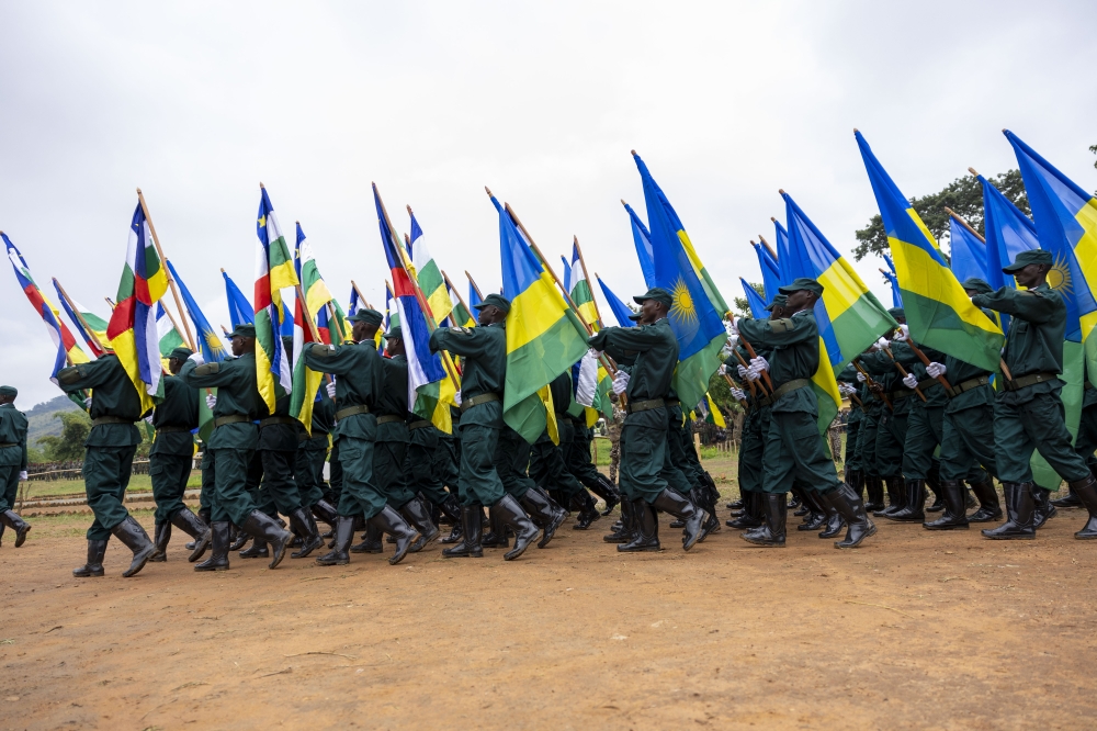 A group of Central African Republic (CAR) soldiers, who were trained by the Rwanda Defence Force (RDF) under a bilateral agreement on defence between the two countries, march with Rwandan and CAR flags at the graduation ceremony on Friday, November 24. Olivier Mugwiza /The New Times