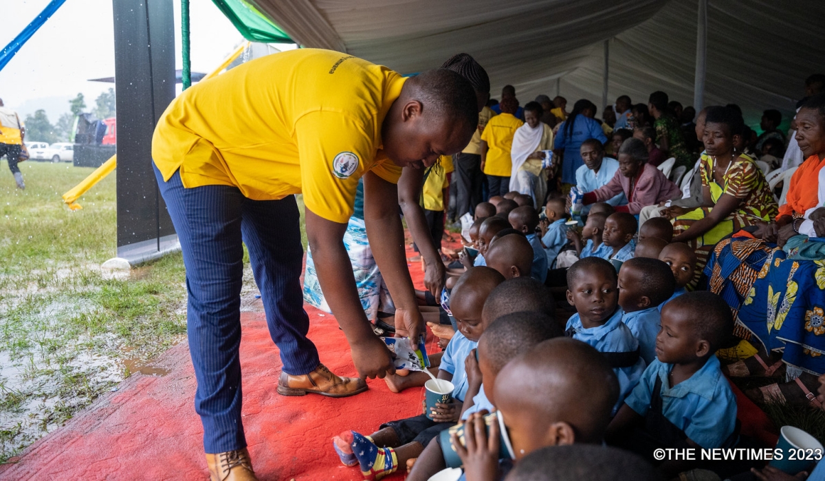 Officials give milk to the children during the event to RBC celebrate child health care week in Nyamashake on November 27. All Photos by Craish BAHIZI
