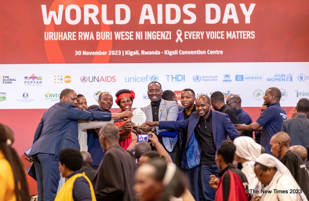 Some youth celebrate an award that they recieved as RBC acknoledged some individuals and organisations that play vital role in fighting against HIV-AIDS. DAN GATSINZI