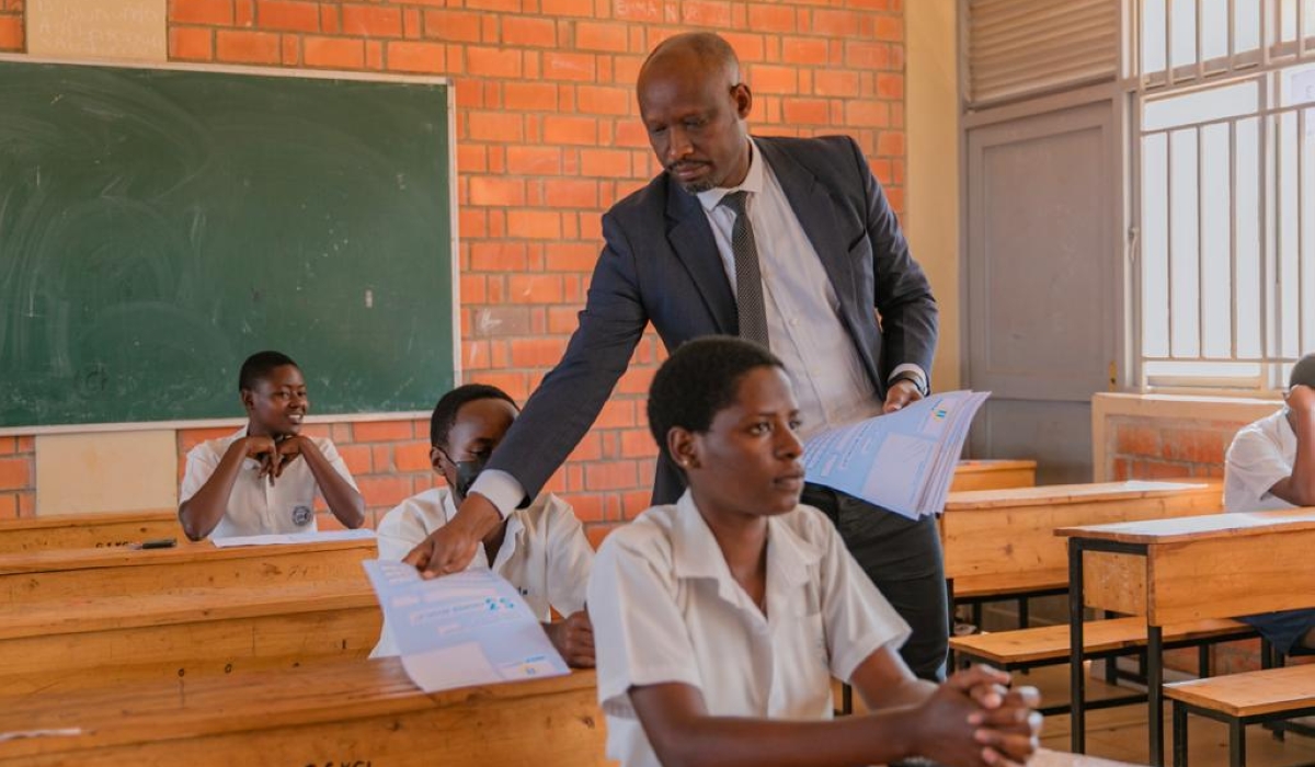 Permanent Secretary at the Ministry of Education, Charles Karakye distributes exam papers during the launch of the national exams on Tuesday, July 25. Results will be unveiled on Monday, December 4, at 1 pm.