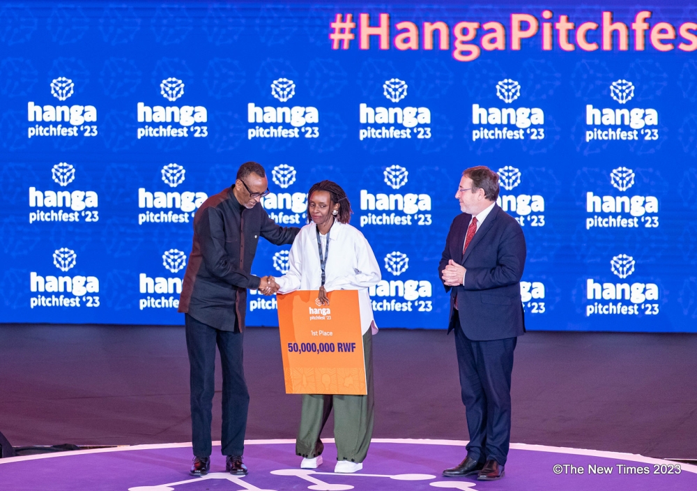 President Paul Kagame congratulating and awarding Cynthia Umutoniwabo, the Chief Executive and Founder of Loopa, the overall winner of Rwanda&#039;s largest startup competition, who took home a cash prize of Rwf50 million on Friday, December 8. All photos by Dan Gatsinzi