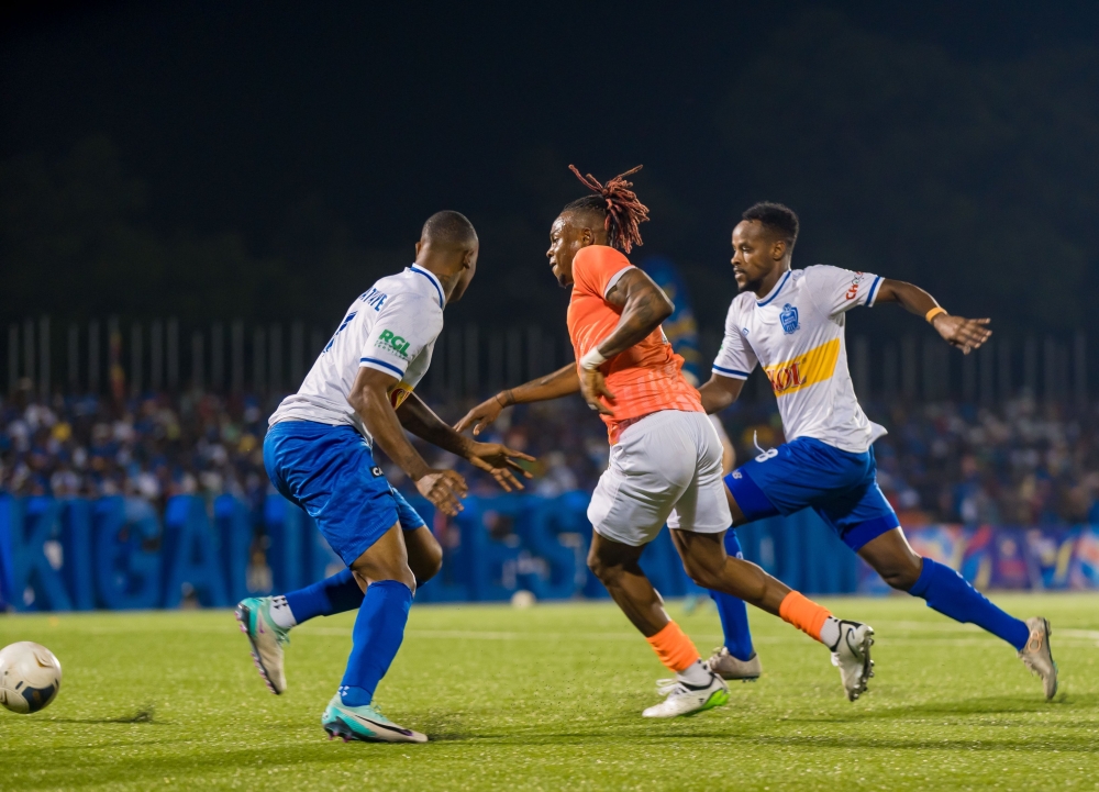 AS Kigali striker Kone Lottin Felix eliminates Rayon Sports defender Abdoul Rwatubyaye and midfielder Rashid Kalisa as Kigali City sponsored team  upset the Blues 2-1 on Saturday at Kigali Pele Stadium . Courtesy