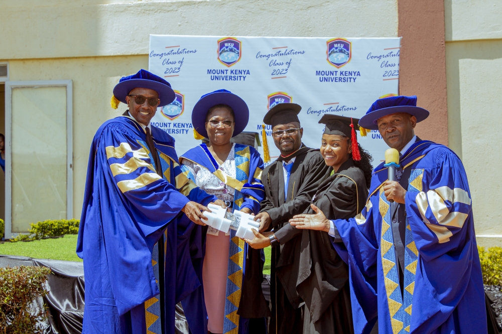 Dr. Innocent Mugisha and Dr. Martin Kimemia (right) appreciating Furaha Charlene with a gift assisted by the DVC academics, Dr. Kechi Irechukwu and a member of staff from the School of Journalism and Mass Media, Mr Eluid