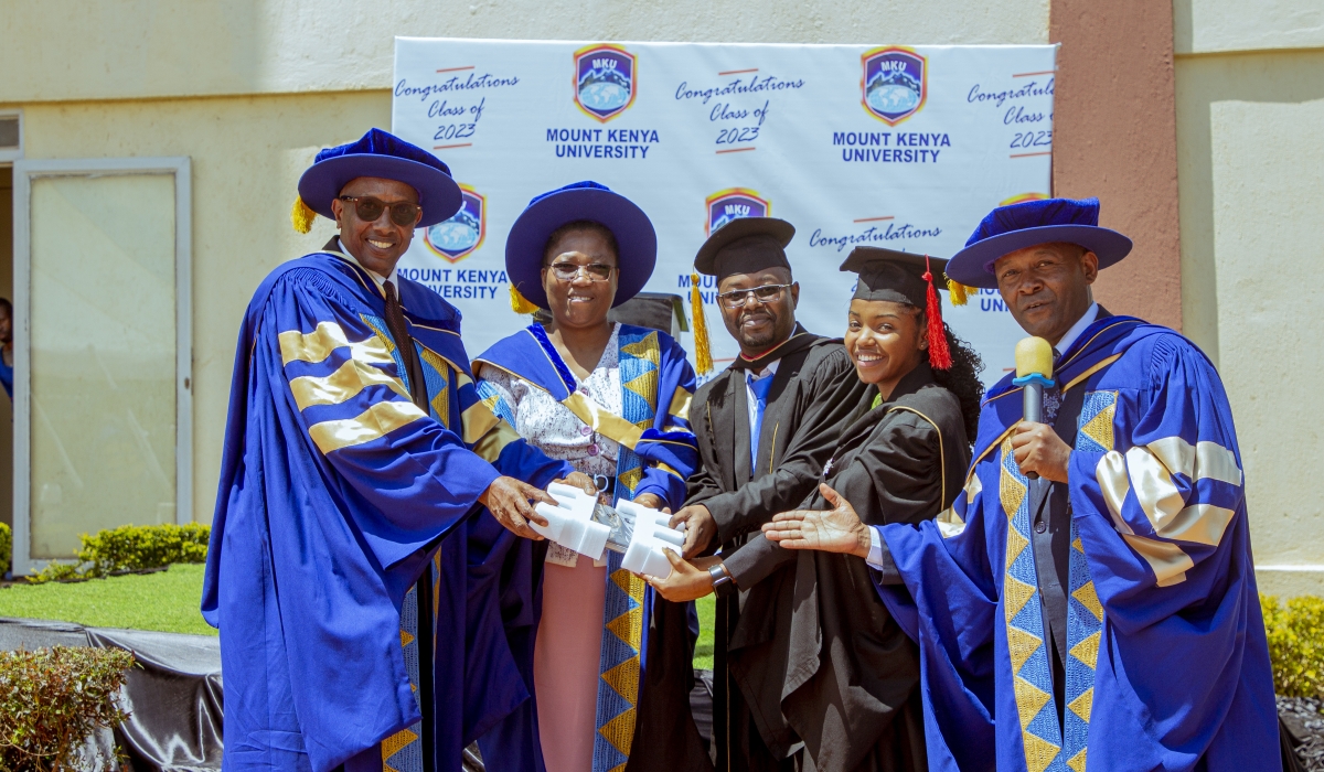 Dr. Innocent Mugisha and Dr. Martin Kimemia (right) appreciating Furaha Charlene with a gift assisted by the DVC academics, Dr. Kechi Irechukwu and a member of staff from the School of Journalism and Mass Media, Mr Eluid