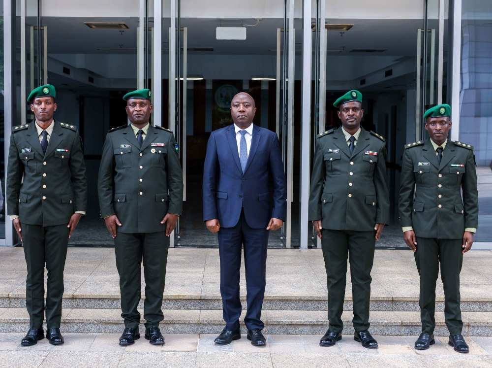 Prime Minister Edouard Ngirente poses for a photo with the new military prosecutors, Captain Jacques Kwizera and Lieutenant Colonel Jean Bosco Kamirindi (Left) and Lieutenant Colonel Jean Paul Mubiligi Rwamfizi and Captain Gaspard Ndayambaje (Right) after a swearing-in event on Tuesday, December 12. COURTESY.