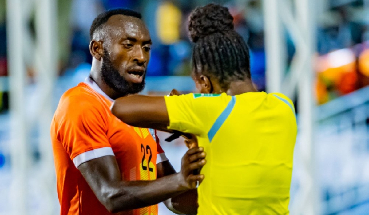 AS Kigali defender Jean Bosco Akayezu (L) talks to referee Aline Umutoni as he tried to avoid a second yellow card for a bookable offense on Arsene Tuyisenge during his side&#039;s 2-1 victory over Rayon Sports at Kigali Pele Stadium on Saturday, December 9- Julius Ntare/IGIHE 