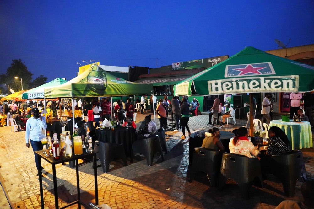 Clients enjoy themselves at Kisimenti car-free zone. Rwanda Development Board (RDB) relaxed the existing nighttime restrictions, lifting them on the weekends altogether. PHOTO BY CRAISH BAHIZI