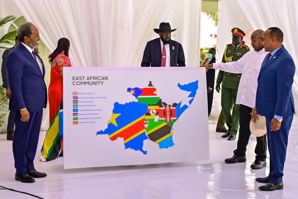 Somalia’s President Sheikh Hassan Mohamud (left), the Chairperson of the EAC Summit, President Salva Kiir of South Sudan (centre), Ugandan President Yoweri Kaguta Museveni, and EAC Secretary General Peter Mathuki, look at the new map of the regional bloc after Somalia inched closer to joining the seven-member Community by signing the Treaty of Accession with the EAC at State House, Entebbe, Uganda on Friday, December 15.