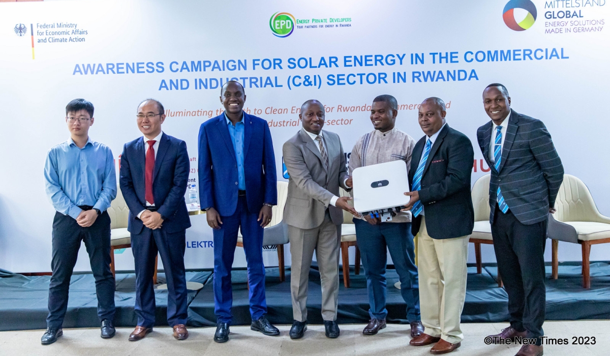 Officials pose for a photo during a major awareness campaign of solar energy in Rwanda’s commercial and industrial sectors on Wednesday, December 13. PHOTOS BY DAN GATSINZI