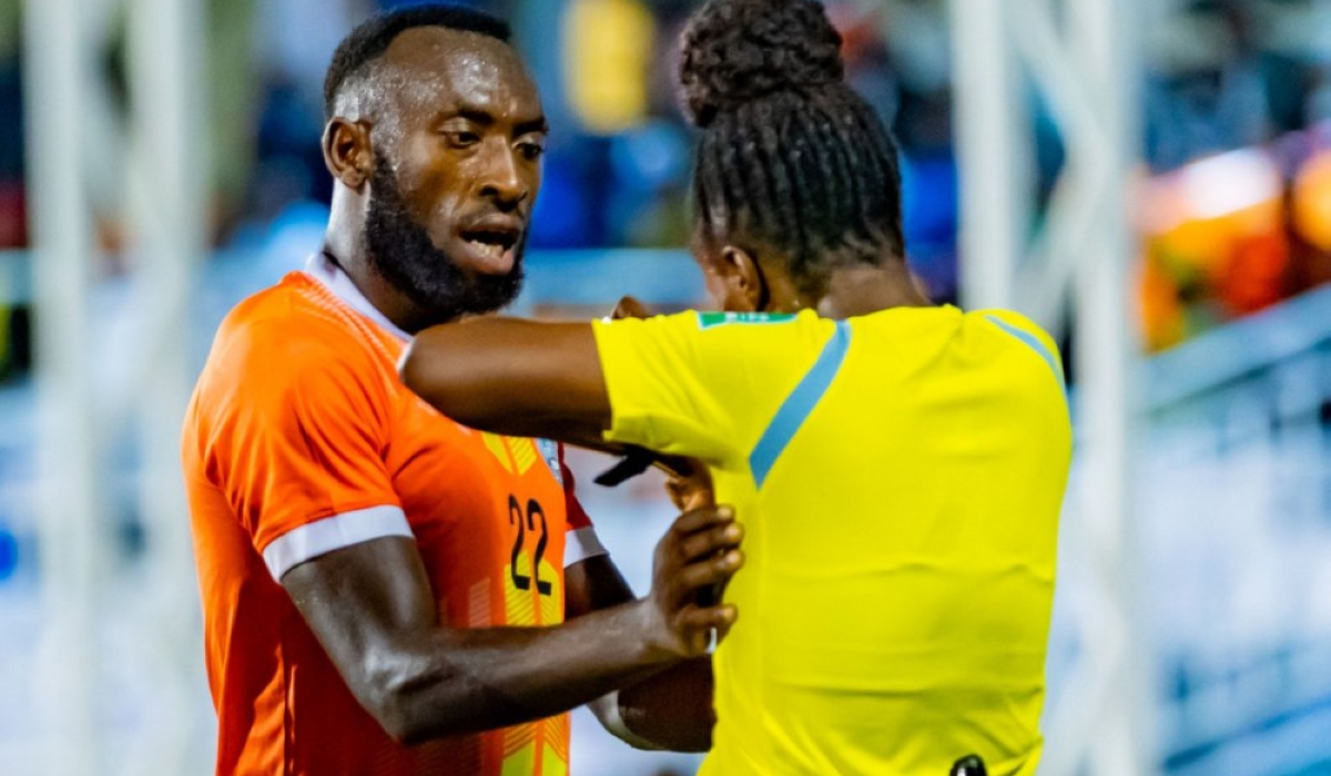 AS Kigali defender Jean Bosco Akayezu talks to referee Aline Umutoni during the game against Rayon Sports at Kigali Pele Stadium on Saturday, December 9. Photo by Julius Ntare, Igihe 