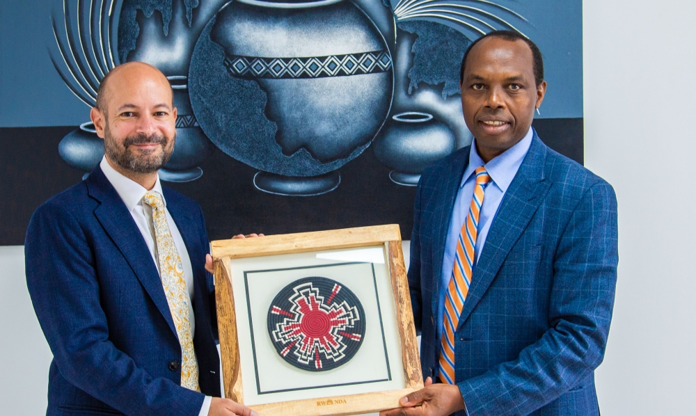 Francis Gatare, the CEO of Rwanda Development Board and Omar Daair, the UK High Commissioner to Rwanda exchange a gift. Courtesy