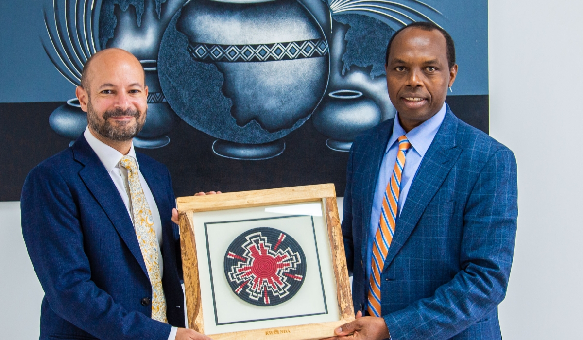 Francis Gatare, the CEO of Rwanda Development Board and Omar Daair, the UK High Commissioner to Rwanda exchange a gift. Courtesy