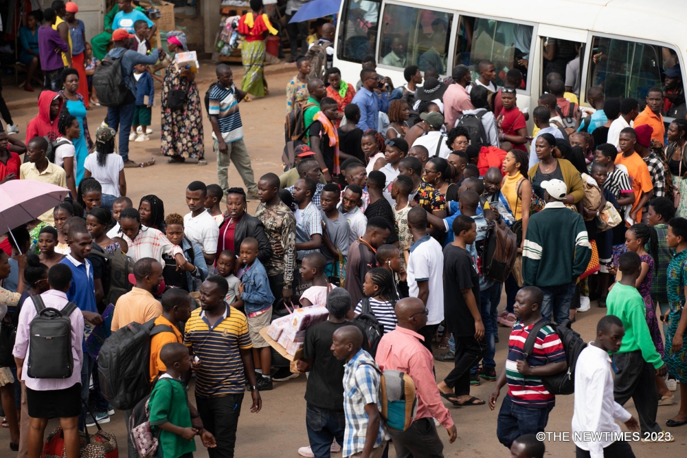 Passengers board bus while heading upcountry to enjoy the New Year. Photo by Craish Bahizi