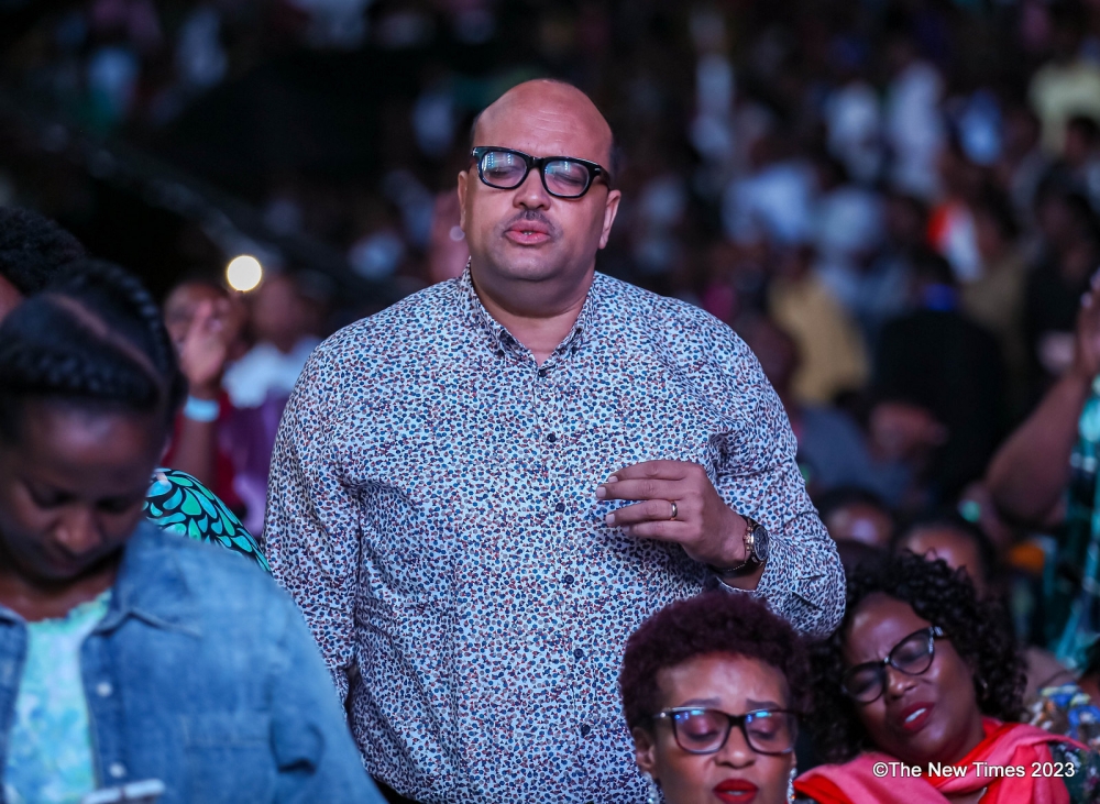 Pastor Alain Numa feels the atmosphere of worship that covered the hall, from the beginning to end. Pastor Numa was among thousands of believers who attended the congregation while  welcoming the New Year 2024. All Photo by Dan Gatsinzi