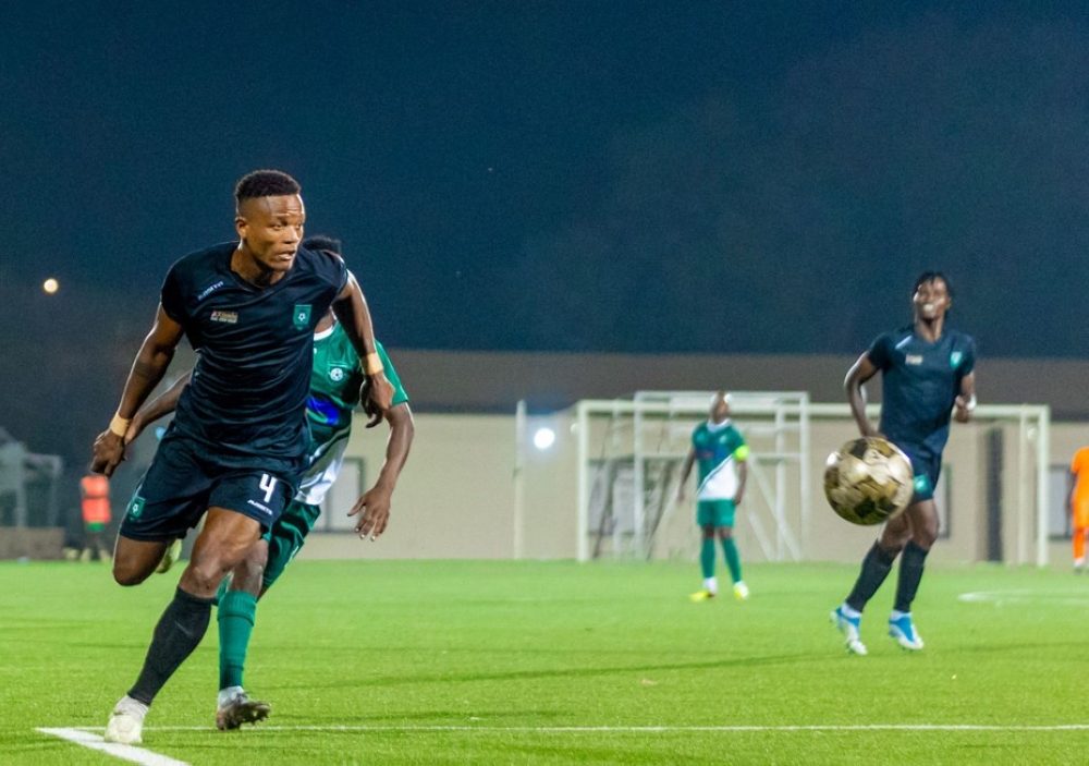Muhazi United defender  Yvan Marcel Dikoume Kouathe goes past SC Kiyovu defender during the game. Police FC are bent on signing central defender Yvan Marcel Dikoume. PHOTO BY JULIUS NTARE