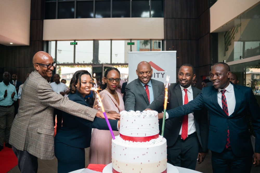 Equity Bank Rwanda officials cut a cake during the celebration as the bank officially launched the revamped operations across the country, following the completion of a merger with Cogebanque Plc. Courtesy