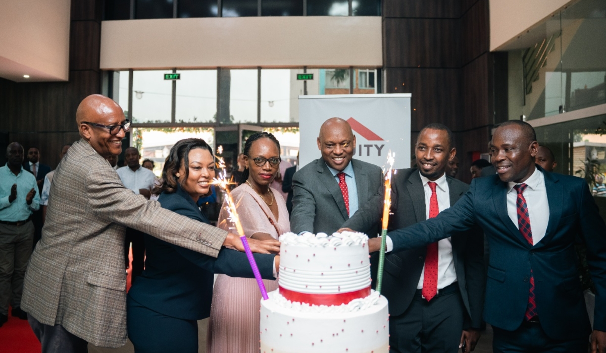 Equity Bank Rwanda officials cut a cake during the celebration as the bank officially launched the revamped operations across the country, following the completion of a merger with Cogebanque Plc. Courtesy