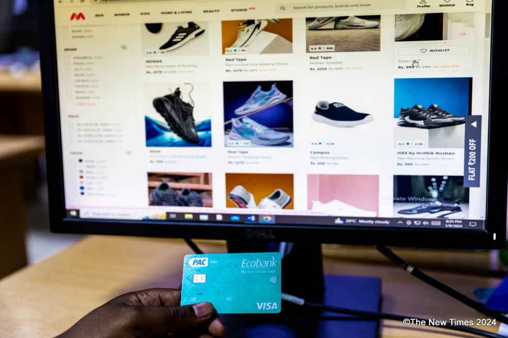 A client buying shoes online. In Rwanda, e-commerce is relatively new, but the sector is growing, thanks in large part to local tech start-ups and international players that have entered the local market in the past few years. Photo by Dan Gatsinzi 