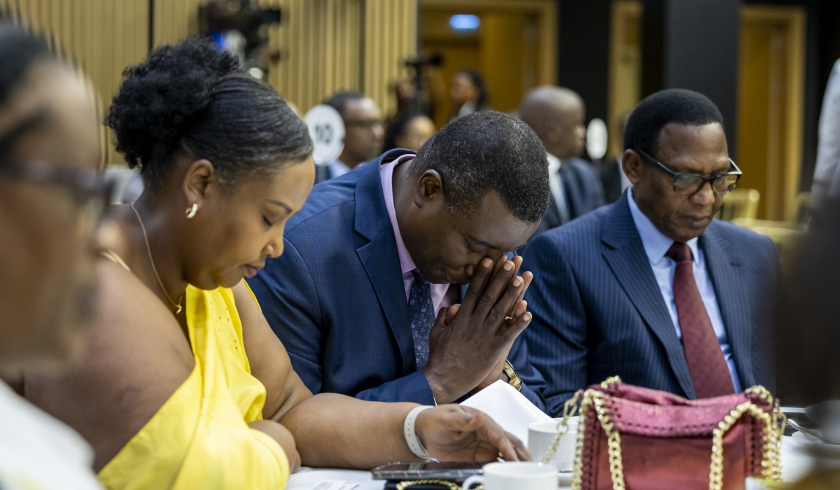 Apostle Paul Gitwaza, the senior pastor at Zion Temple (C), and Dodo Twahirwa, CEO of Jali Transport (R) during the 29th annual National Prayer Breakfast  at Kigali Convention Centre on Sunday, January 14.The annual event brought together government officials, private sector leaders, diplomats, and senior religious leaders, among others. All photos by Olivier Mugwiza