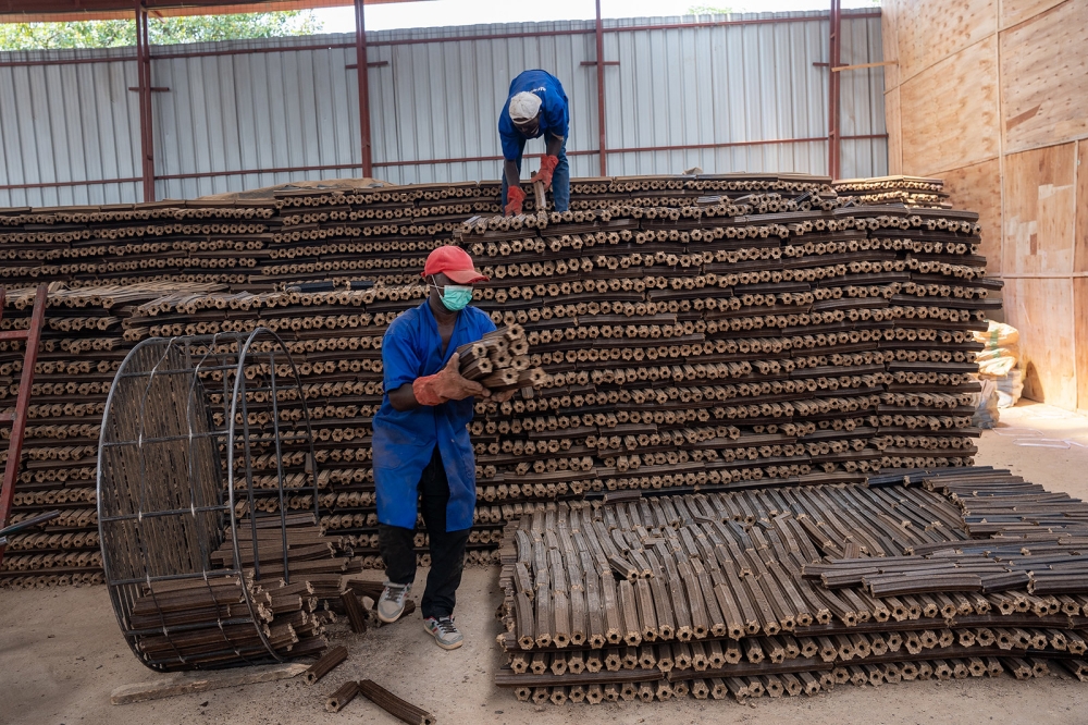 Workers at a factory that produces briquettes in Mageragere Sector in Nyarugenge District. Photo: Willy Mucyo