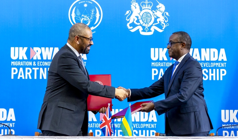 The Minister of Foreign Affairs and International Cooperation, Vincent Biruta (right), and UK Home Secretary James Cleverly shake hands after signing a new migration treaty between the two countries in Kigali, on December 5, 2023. Photo: Olivier Mugwiza