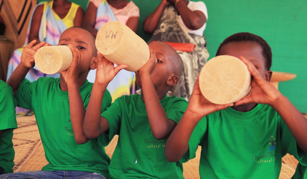 Children drink milk during Umuganura in Nyanza District. Sam Ngendahimana