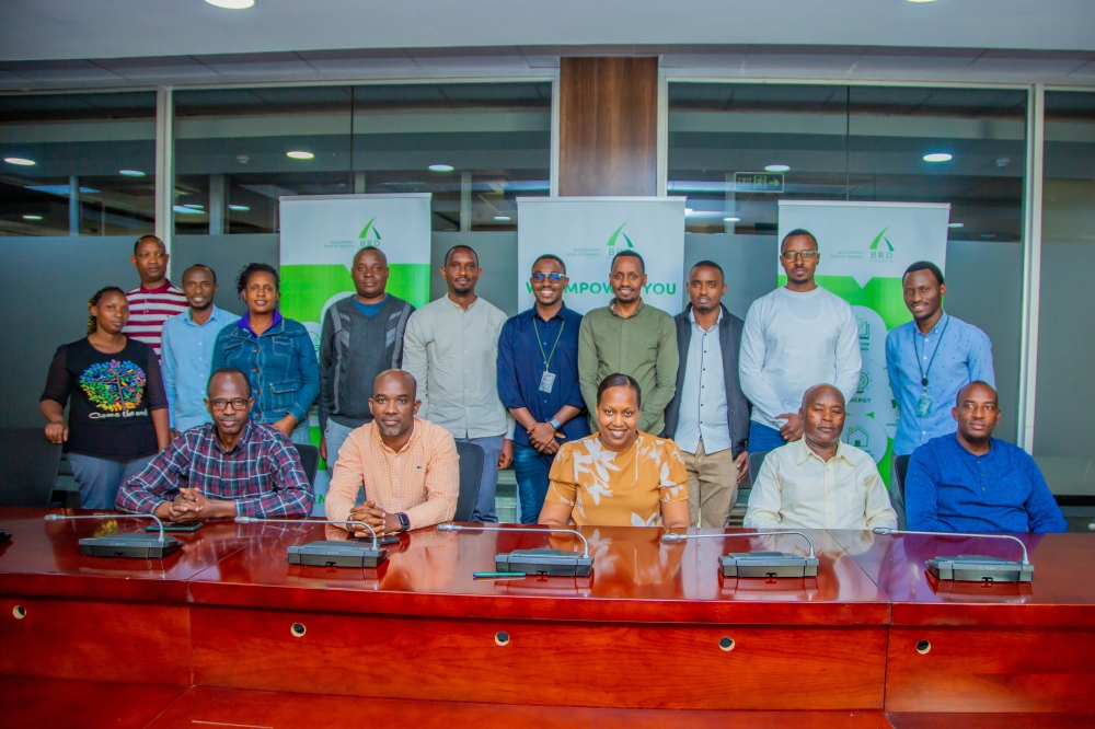 Pitchette Kampeta Sayinzoga (centre, bottom row), CEO of the Development Bank of Rwanda, poses for a group photo with public transport operators.