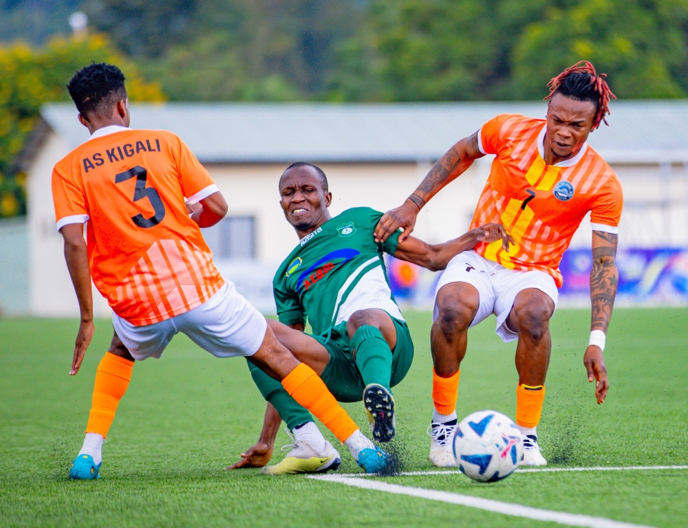 AS Kigali players battle for the ball with Kiyovu player during a 1-0 league match  at Kigali Pele stadium on Saturday. Photo by Julius Ntare