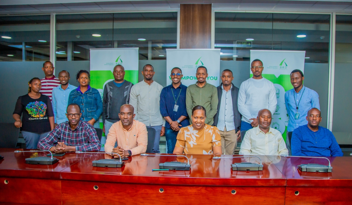 Pitchette Kampeta Sayinzoga (centre, bottom row), CEO of the Development Bank of Rwanda, poses for a group photo with public transport operators.