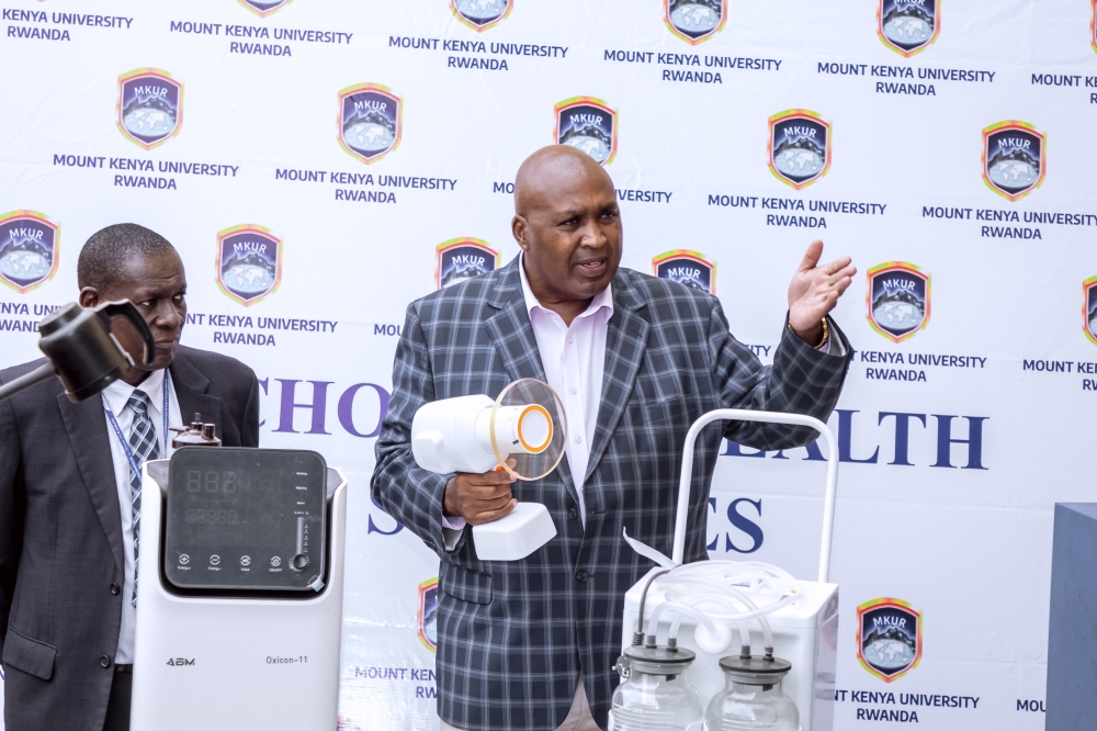 Prof. Simon Gicharu explains how the Ezray Air portable machine for X-ray, which helps in diagnosing dental disorders works to members of staff last year. Looking on is the former Acting Vice-Chancellor, Prof. Edwin Odhuno.