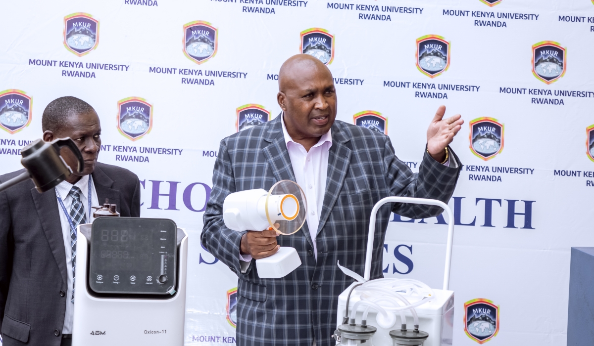 Prof. Simon Gicharu explains how the Ezray Air portable machine for X-ray, which helps in diagnosing dental disorders works to members of staff last year. Looking on is the former Acting Vice-Chancellor, Prof. Edwin Odhuno.