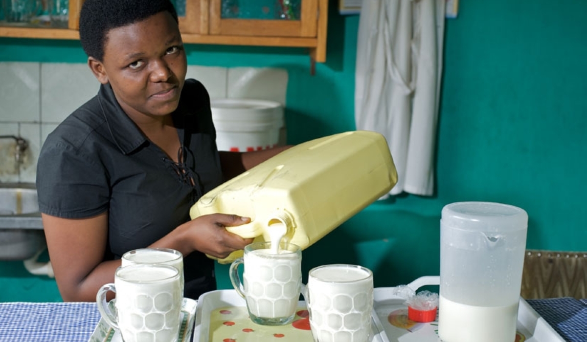 A milk seller serving customers in her milk bar in Kigali. File